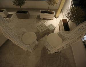 an overhead view of chairs and plants on a floor at The White Suites in Adamantas