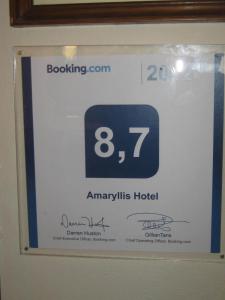 a sign in a bathroom with a clock on it at Amaryllis Hotel in Karpathos