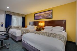 A bed or beds in a room at SureStay Plus Hotel by Best Western Chula Vista West