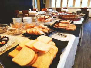 a table topped with lots of different types of bread at Hotel Miravalle in San Miniato