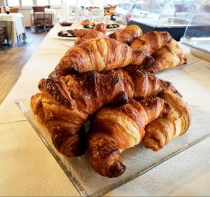 ein Tablett mit Croissants und anderem Gebäck auf dem Tisch in der Unterkunft Hotel Miravalle in San Miniato