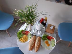 a table with three plates of breakfast food on it at Hoai River Hoi An Homestay in Hoi An