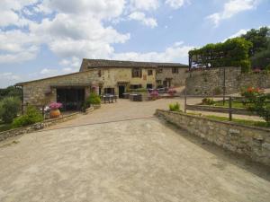 an external view of a stone building with a driveway at Antico Borgo Poggiarello in Monteriggioni