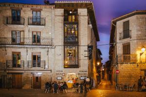 a street in an old town at night at Hotel Ducay in Olite