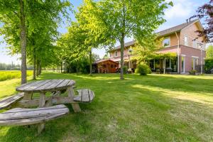 a picnic table in the grass in front of a house at Huis van Steen in Lelystad