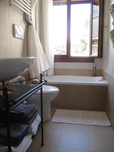 a bathroom with a tub and a toilet and a sink at Abitazione Morosini Apartment in Venice