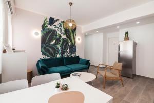 a living room with a green couch and a refrigerator at 36 Geula - By Beach Apartments TLV in Tel Aviv