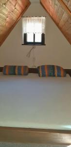 two pillows sitting on a shelf under a window at Chalupa U Studánky in Adršpach