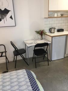 a kitchen with a table and chairs in a room at Modern, private and close to town. in Albury