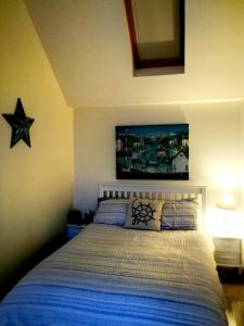 a bedroom with a bed with a star on the wall at Sma Harbour Hoose in Gourdon