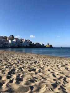 a sandy beach with footprints in the sand at Castel Abaso Boutique Apartments by Explore Andros in Andros
