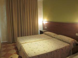 Postel nebo postele na pokoji v ubytování Hotel Totana Sur