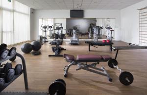 a gym with weights and exercise equipment in a room at Hotel Cube in Ravenna