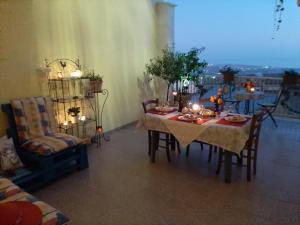 a dining room with a table and chairs with candles at terre di girgenti in Agrigento