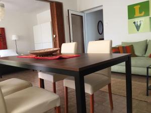 a dining room with a table and white chairs at Domic ,Two Bedrooms whit Large Terrace in Njivice
