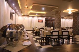 a dining room with a table and chairs and a table and chairsktop at Hotel Pushkar Legacy in Pushkar