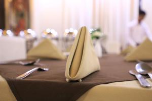 a table with two napkins and utensils on top of a table at Hotel Pushkar Legacy in Pushkar +37 photos