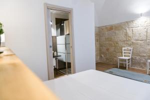 Postel nebo postele na pokoji v ubytování Donato Rooms
