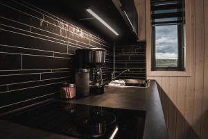 a kitchen with a counter with a coffee maker on it at Afternoon Cottages in Hella