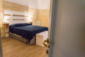 Postel nebo postele na pokoji v ubytování Donato Rooms