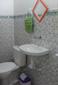 a bathroom with a toilet and a sink at Pousada Flanboyan in São Miguel do Gostoso