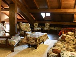 a living room with chairs and a table and a couch at Antico Borgo dell'Anconella - grande appartamento rustico in Anconella