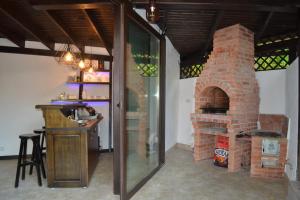 a brick oven in a room with a bar at Vila Ana in Băile Govora
