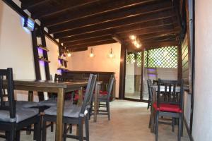 a dining room with a table and chairs at Vila Ana in Băile Govora +17 photos