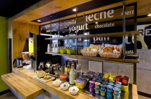 a bakery with a counter with food and drinks at Ibis Budget Madrid Getafe in Getafe