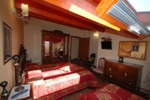 a bedroom with a large bed and a dresser and a mirror at B&B La Ginestra in Civita