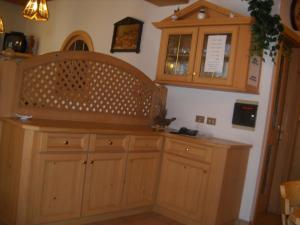 a kitchen with wooden cabinets and a counter at B&B Chiara- Alleghe in Alleghe +25 photos