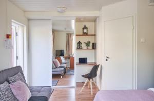 a bedroom with a couch and a living room at Hotel Villa Molnby in Porvoo