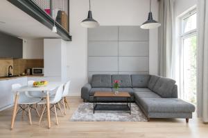 a living room with a couch and a table at Easy Apartments Wrocław in Wrocław