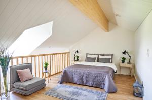 a bedroom with a bed and a chair in a attic at Apartments in Porvoo in Porvoo
