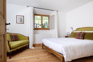 ラ・プン・シャミュ・シアシにあるChes'Ota - La Puntのベッドルーム1室(ベッド1台、緑の椅子付)