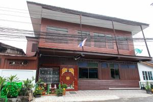 a wooden building with a flag in front of it at Arku’s House in Chiang Mai