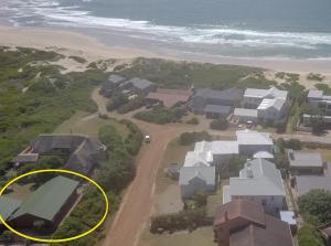 an aerial view of a house on the beach at CHARMING BEACH BUNGALOW in Cape St Francis