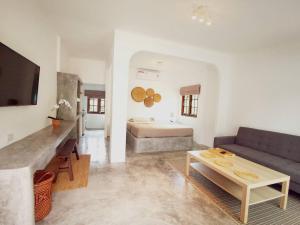 a living room with a couch and a bed at LiLi's Rooms in Ko Lanta