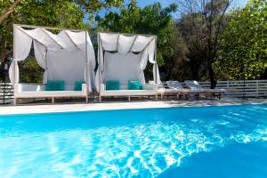 a group of chairs and a swimming pool at Ideal House in Parga