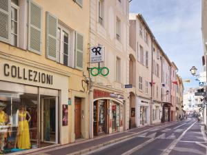 a city street with shops and buildings on a street at Maison Panthère - Luxury Harbour Residence in Saint-Tropez