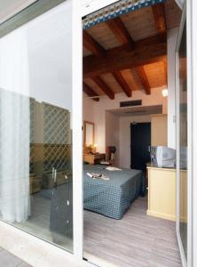 a bedroom with a bed and a sliding glass door at Hotel Mary in Campalto