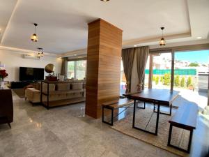 a living room with a table and a couch at Ultra Luxury Private Villa with Swimming Pool in Bodrum City