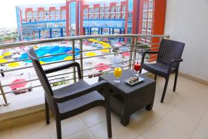 a balcony with a table and two chairs and a view of a pool at Tolip El Narges in Cairo