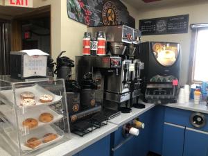 a counter with a coffee shop with doughnuts on it at Exxon Quik Stop & Motel in Wausaukee