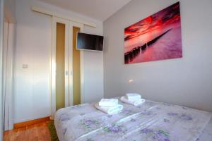 a bedroom with a bed with two towels on it at Apartments Belville in Belgrade