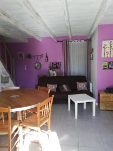 a living room with a table and a couch at Contre Vents et Marais in Vix