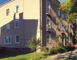 a building with a shadow on the side of it at 7Domb Apartman in Komló