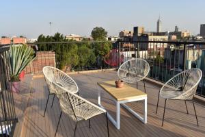 three chairs and a table on a balcony at Casa Azul for groups since 4 till 30 persons in Mexico City