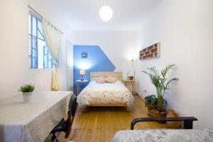 a bedroom with two beds and a blue ceiling at Casa Azul for groups since 4 till 30 persons in Mexico City