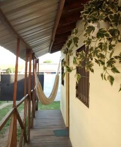 a porch of a house with a hammock at Cabañas Puerto Surf in Mar del Plata